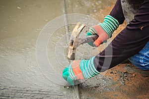 Grooving on concrete pavement by worker used deformed steel bar