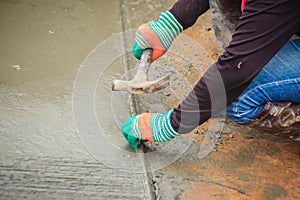 Grooving on concrete pavement by worker used deformed steel bar