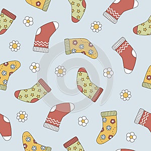 Groovy Christmas seamless pattern with socks and flowers in trendy retro cartoon style. Background for winter festive