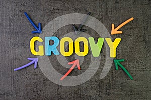 Groovy modern programming language for software development or application concept, multi color arrows pointing to the word Groovy