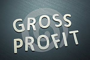 Gross profit written with wooden letters on a green background