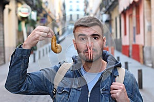 Grossed out man cleaning an excrement photo