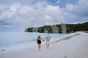 Grote knip beach Curacao, Island beach of Curacao in the Caribbean men and woman on vacation visit the beach