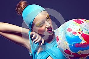 Grotesque. Eccentric Woman with Fancy Stagy Makeup and Air Balloon photo