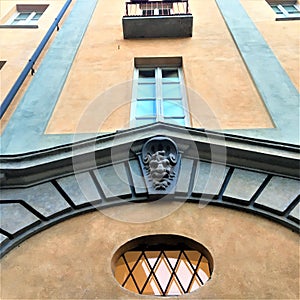 Grotesque mask, windows, wall, architecture, art and beauty