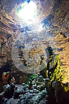Grotta di Castellano, Apulia - Impressive stone formations illuminated through a hole photo