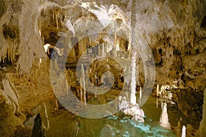 Grotta di Frasassi, Genga, Italy. Lake in the cave, Stalactites and stalagmites closeup