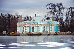 Grotto pavilion in the Tsarskoe Selo with big pond covered with ice, St. Petersburg, Russia