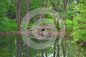 Grotto on a pond in Dendrology garden in Pereslavl-Zalessky city