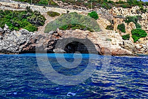 A grotto in a rock under the highway to Alanya Turkey - view from the sea. Large cave with concrete blocks inside against the