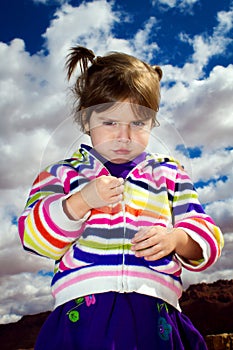 Grouchy Toddler Looking Down On Camera photo