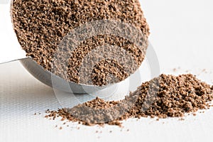 Ground Allspice Spilled from a Teaspoon