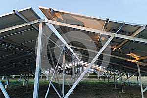 Ground based steel frame of large sustainable electrical power plant with rows of solar photovoltaic panels for