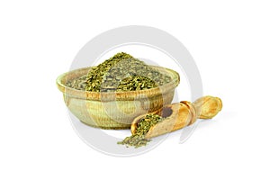 Ground Bay leaf in a wooden cup with a spoon for spices isolated on a white background. Collection of spices and herbs