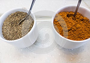 Ground black pepper and cayenne pepper in the porcelain cup