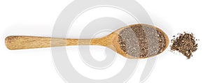 Ground black pepper in wooden spoon isolated on white background. Top view