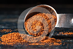 Ground Cayenne Pepper Spilled from a Teaspoon