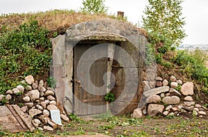 Ground cellar with wooden door