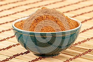 Ground cinnamon in bowl