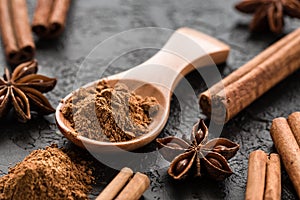 Ground cinnamon spice powder in wooden spoon