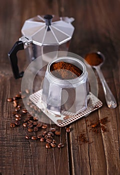 Ground coffee and coffee beans in a Moka Pot