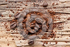 Ground coffee and grain on wood