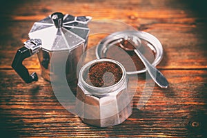 Ground coffee and moka pot photo