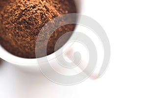 Ground coffee in white cup