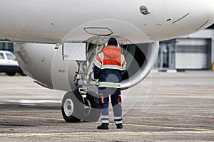 A ground control manager helps to park the aircraft