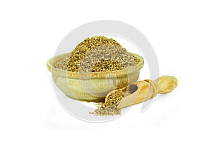 Ground coriander in a wooden cup with a spoon for spices isolated on a white background. Collection of spices and herbs