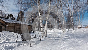 On the ground covered with snow, paths are trodden, nearby are snowdrifts