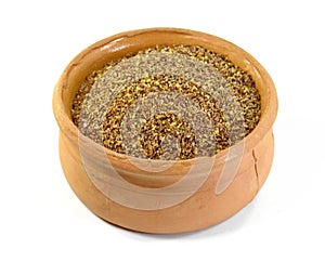 Ground or crushed brown flax seed or linseed isolated on white.