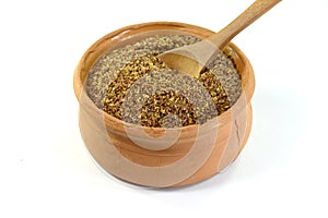 Ground or crushed brown flax seed or linseed isolated on white.