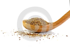 Ground or crushed brown flax seed or linseed isolated on white.