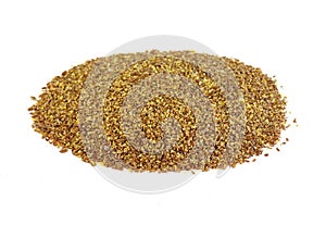 Ground or crushed brown flax seed or linseed isolated on white.