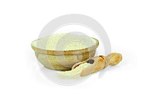 Ground dry garlic in a wooden cup with a spoon for spices isolated on a white background. Collection of spices and herbs