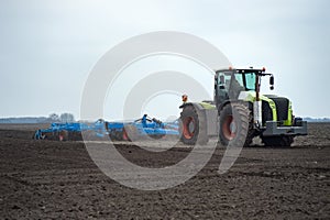 Ground field cultivation with tractor and seedbed cultivator