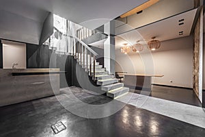 Ground floor of an empty retail space with displays of marble tiles and polished concrete floors