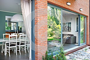 Ground Level Home With Patio Doors Opening To Dining Room  photo