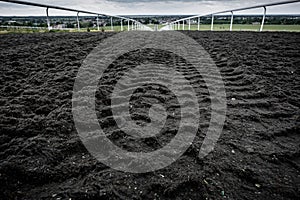 Ground level view of a gallop and horse racing track seen at the top of the hill.