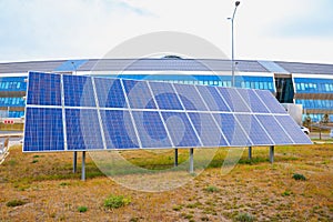 Ground mounted Solar power photovoltaic panels on grass in city, clean energy and environmental power from sunlight to reduce