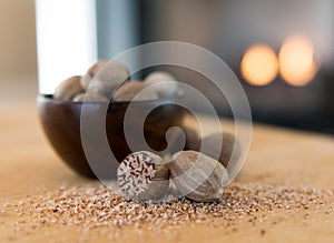 Ground Nutmeg Rests in Front of a Bowl of Nutmeg