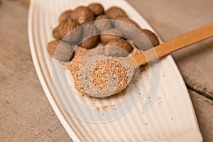 Ground nutmeg spices in a ceramic plate