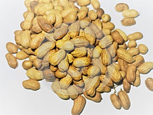 Ground peanuts with sells in blurry white background