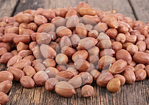 Ground peanuts on wooden background