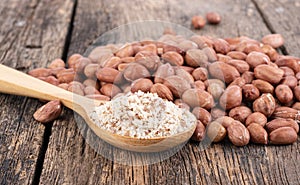 Ground peanuts on wooden background