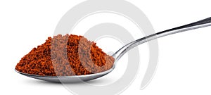 Ground red paprika in spoon isolated on white background