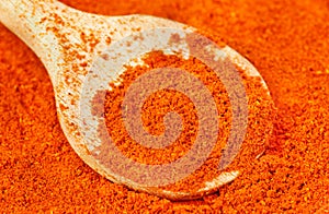 Ground red pepper and wooden spoon