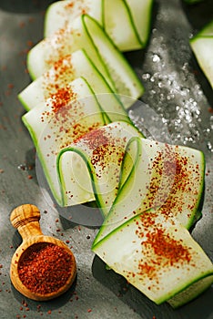 Ground Red Sumac Berries sprinkled on cucumber slice