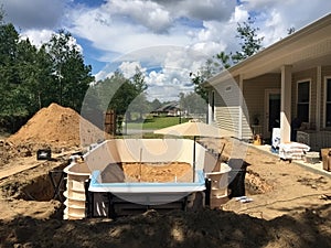 In ground residential swimming pool construction. Prefab walls.